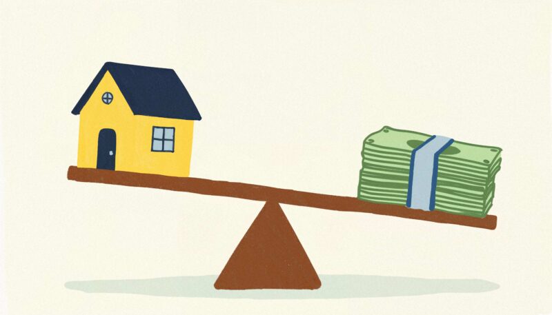 House and money stack on a seesaw illustrating mortgage loan-to-value balance.
