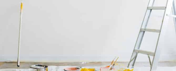 Painting supplies and ladder in a room under renovation, representing strategic home upgrades to improve resale value.