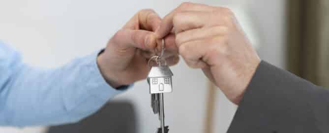 House keys being handed over, illustrating a power of sale home purchase.